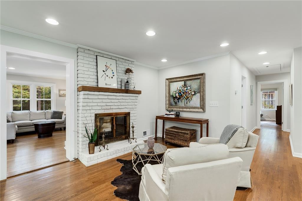 6555 Wright Road Northeast Sandy Springs, GA 30328 - Photo 4 of 40 a living room with furniture a fireplace and a large window
