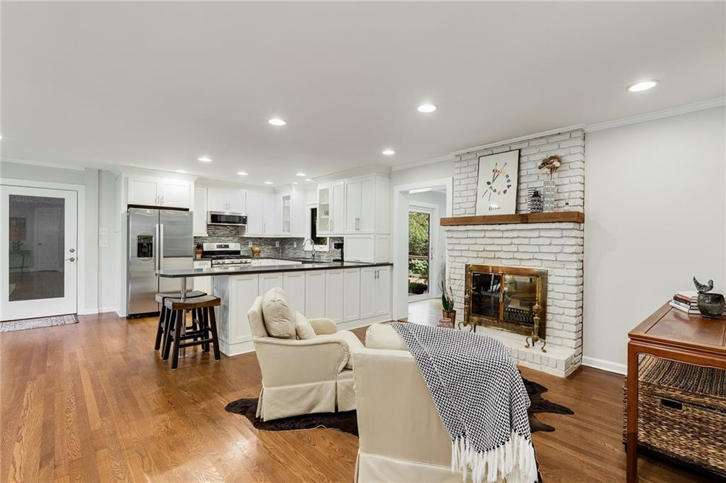 6555 Wright Road Northeast Sandy Springs, GA 30328 - Photo 5 of 40 a living room with furniture and a fireplace