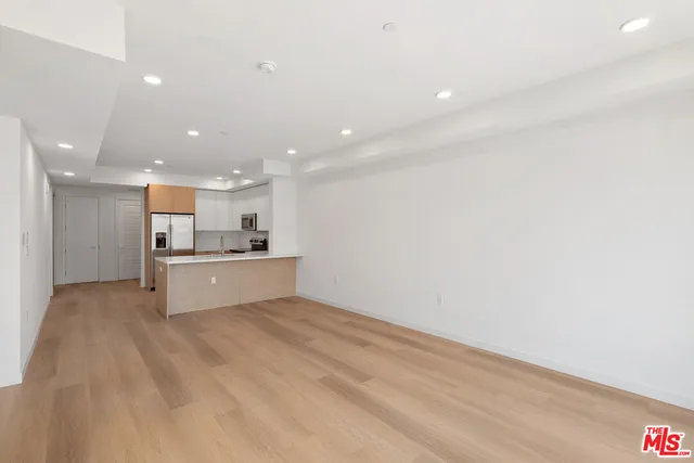 a view of kitchen with kitchen island microwave and stove