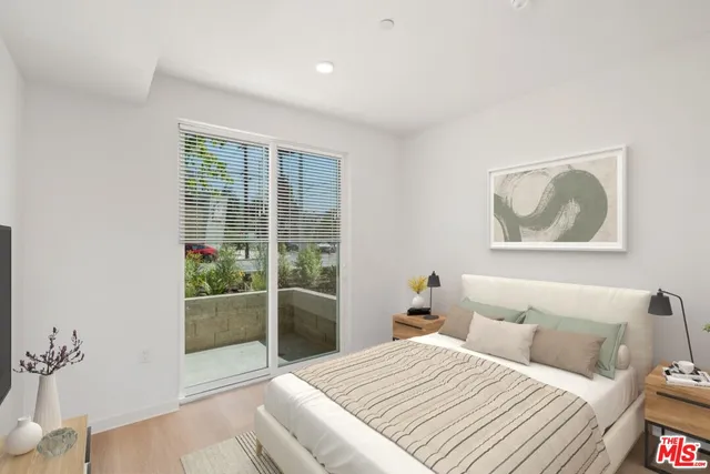 a bedroom with a balcony and a large window