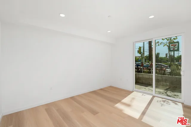 a room with a bed and a large window