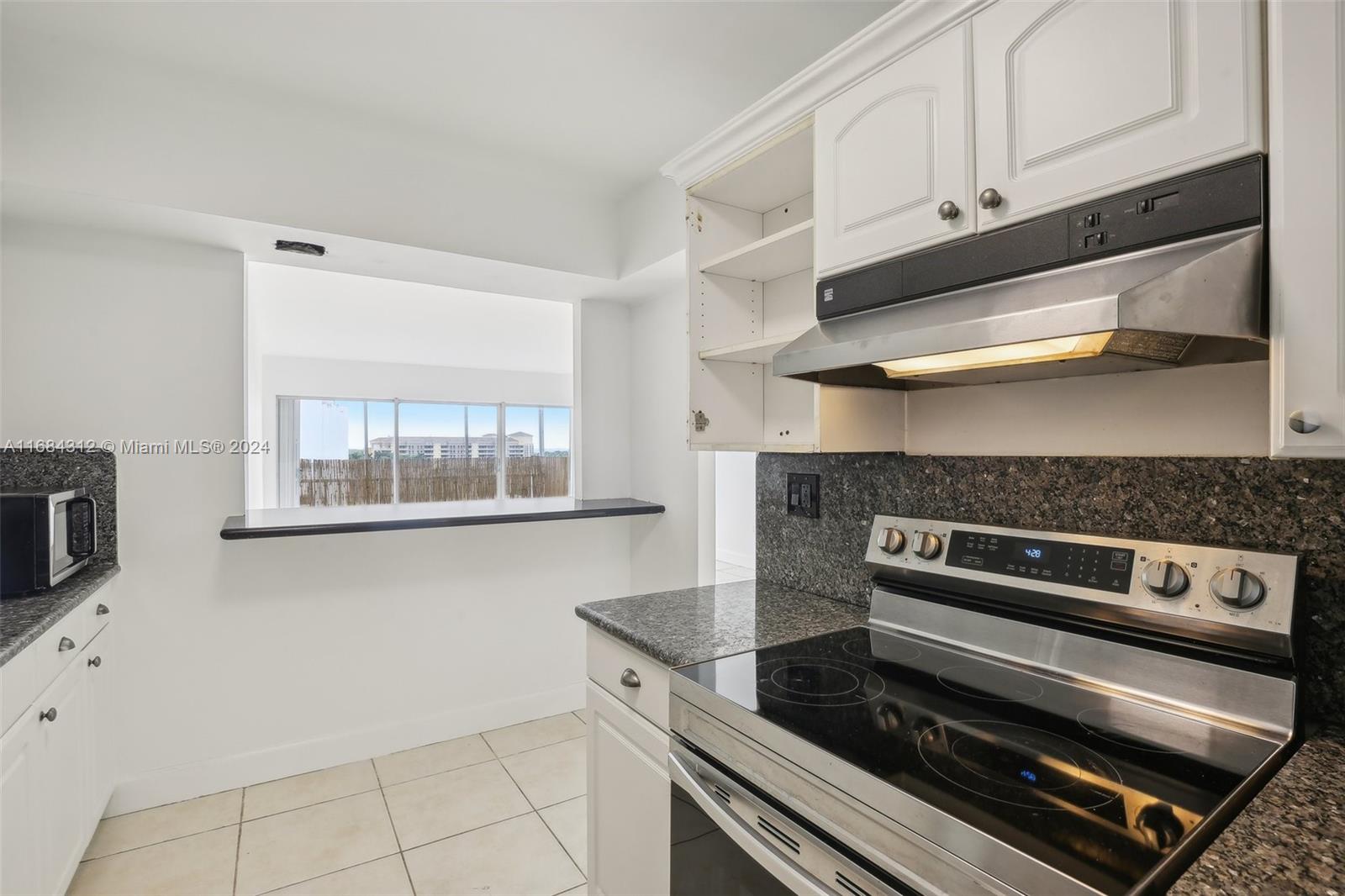 550 Ocean Drive, Unit 9F Key Biscayne, FL 33149 - Photo 30 of 37 a kitchen with appliances and cabinets
