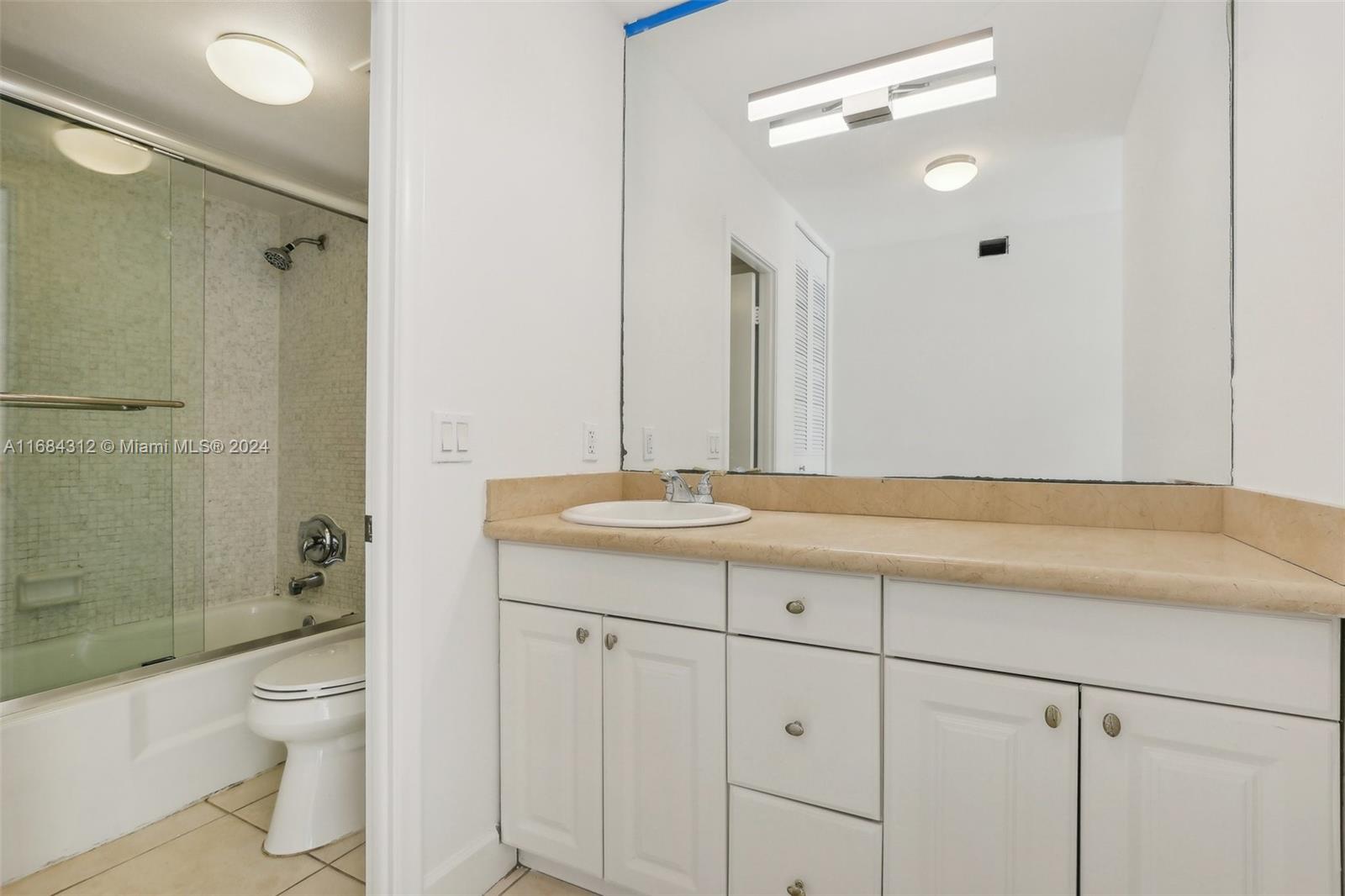 550 Ocean Drive, Unit 9F Key Biscayne, FL 33149 - Photo 9 of 37 a bathroom with a sink a toilet and shower