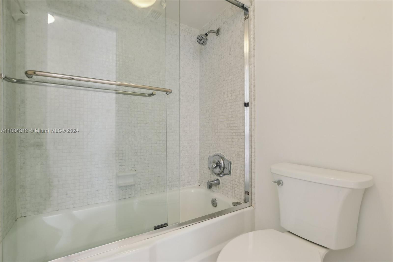 550 Ocean Drive, Unit 9F Key Biscayne, FL 33149 - Photo 10 of 37 a bathroom with a shower and a toilet