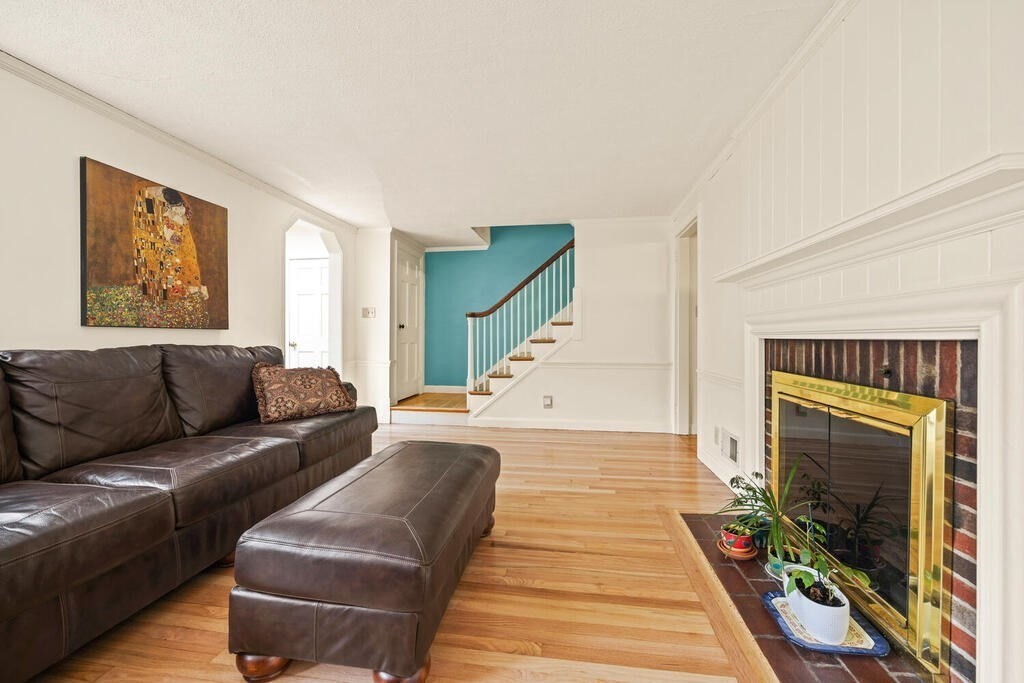 22 Spring Street Lexington, MA 02421 - Photo 5 of 35 a living room with furniture and a fireplace