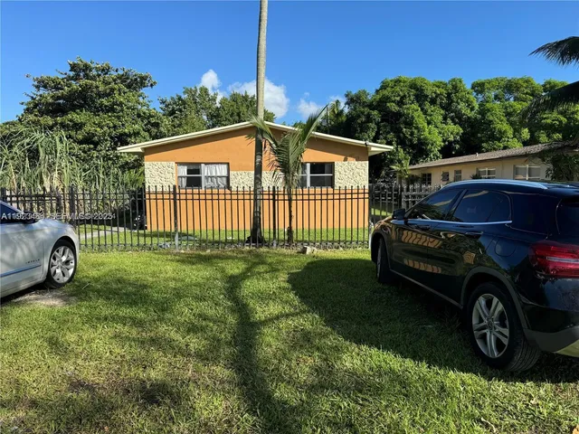 a view of a house with a car parked in it