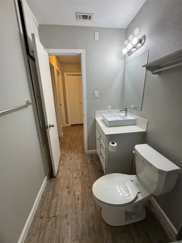 a bathroom with a toilet a sink and a mirror