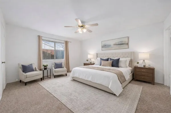 a bedroom with bed couch and window