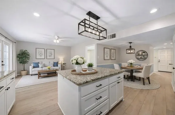 a living room with kitchen island furniture and a table