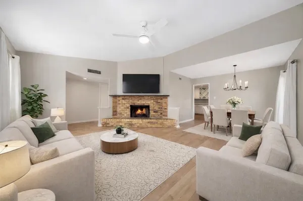 a living room with furniture a fireplace and a flat screen tv