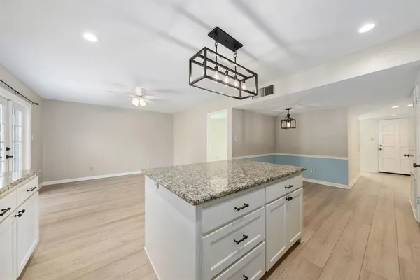 a kitchen with a granite countertop sink and dishwasher