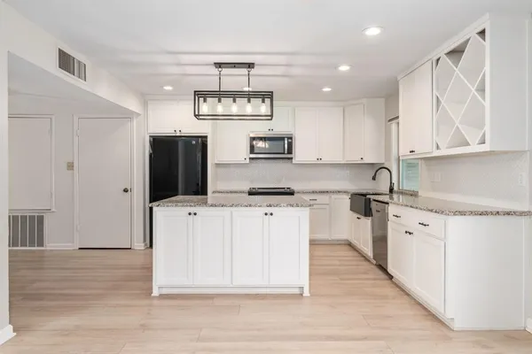a kitchen with a refrigerator and cabinets