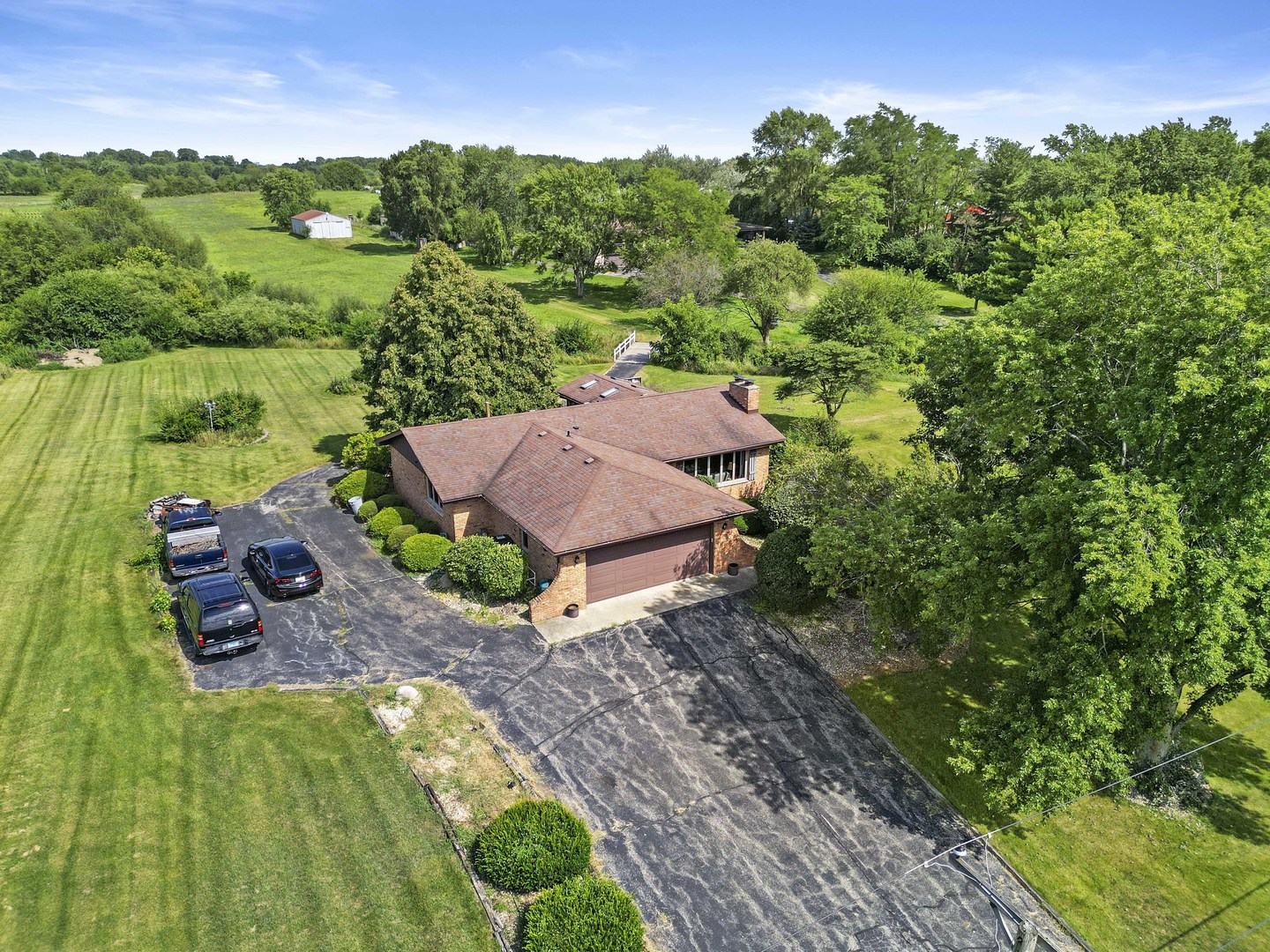 an aerial view of a house with yard swimming pool and outdoor seating