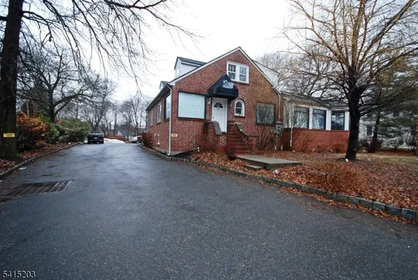 a view of a house with a yard covered in snow