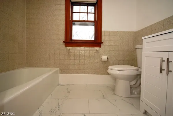 a bathroom with a bathtub and toilet