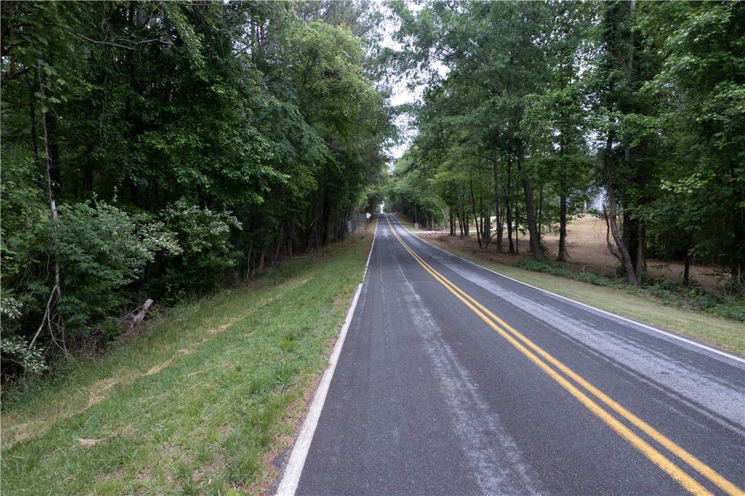 0 Mayfield Heights Road Belton, SC 29627 - Photo 3 of 6 A long, tree-lined road invites peaceful journeys through natural surroundings.