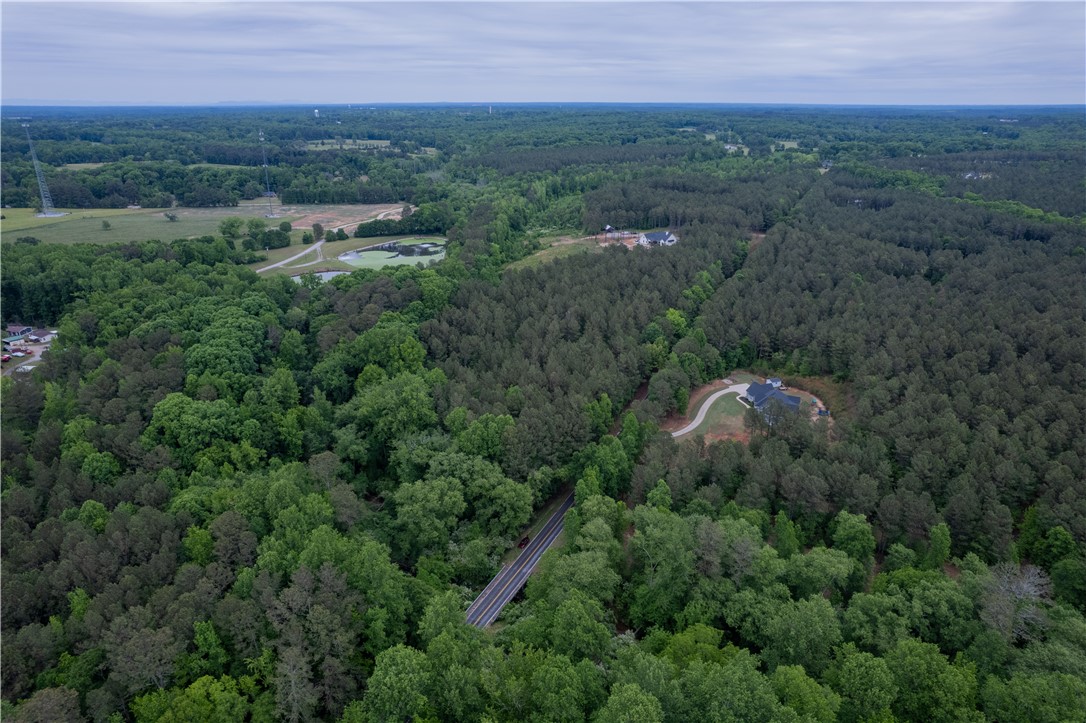 0 Mayfield Heights Road Belton, SC 29627 - Photo 4 of 6 This aerial perspective showcases a vast, verdant landscape with homes nestled within the trees.
