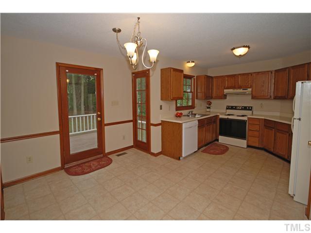 7200 Ewing Place Raleigh, NC 27616 - Photo 11 of 25 a kitchen with stainless steel appliances granite countertop a stove a sink dishwasher and a refrigerator