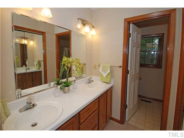7200 Ewing Place Raleigh, NC 27616 - Photo 14 of 25 a bathroom with a sink vanity and a mirror