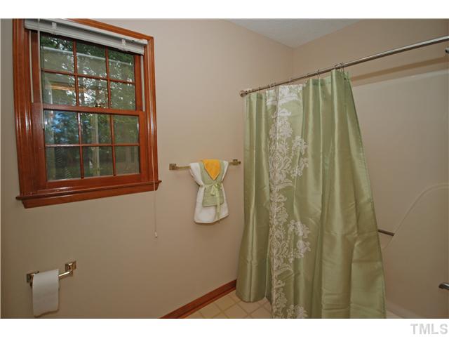 7200 Ewing Place Raleigh, NC 27616 - Photo 15 of 25 a bathroom with a shower and a window