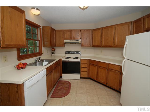 7200 Ewing Place Raleigh, NC 27616 - Photo 6 of 25 a kitchen with stainless steel appliances granite countertop a stove a sink dishwasher and a refrigerator