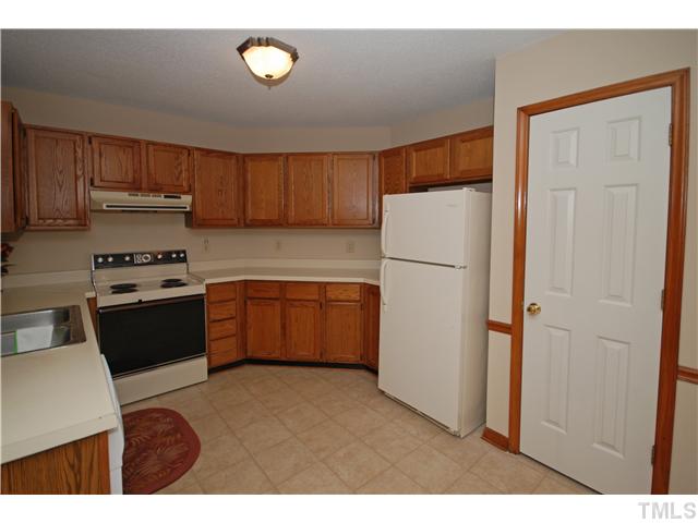 7200 Ewing Place Raleigh, NC 27616 - Photo 7 of 25 a kitchen with a refrigerator sink and cabinets