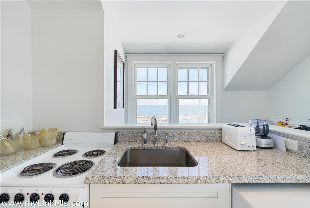100 Baxter Road Nantucket, MA 02554 - Photo 8 of 11 a kitchen with a stove a sink and a large window