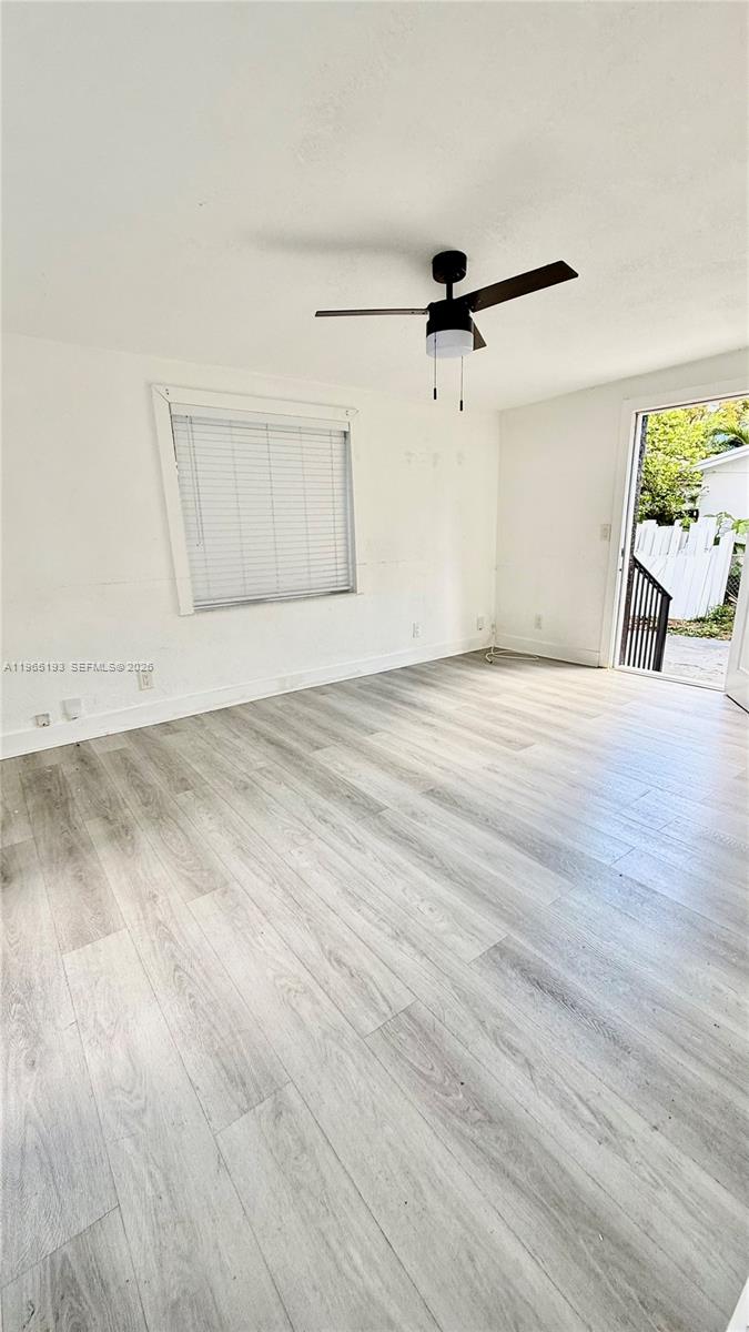 2238 Northwest 5th Street, Unit 1 Miami, FL 33125 - Photo 13 of 18 an empty room with wooden floor and windows
