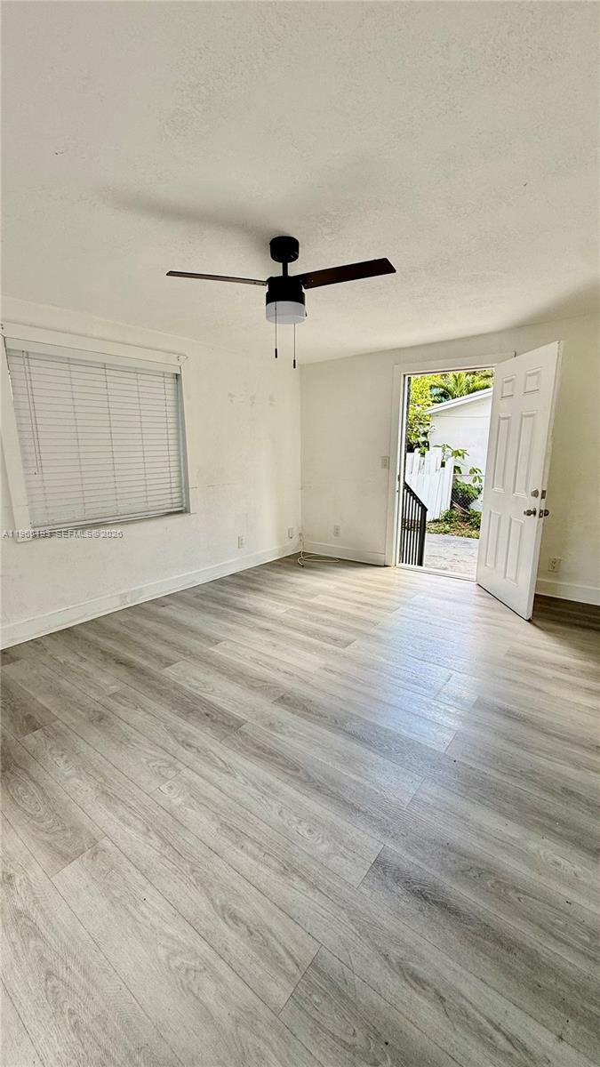 2238 Northwest 5th Street, Unit 1 Miami, FL 33125 - Photo 14 of 18 a view of empty room with wooden floor and window