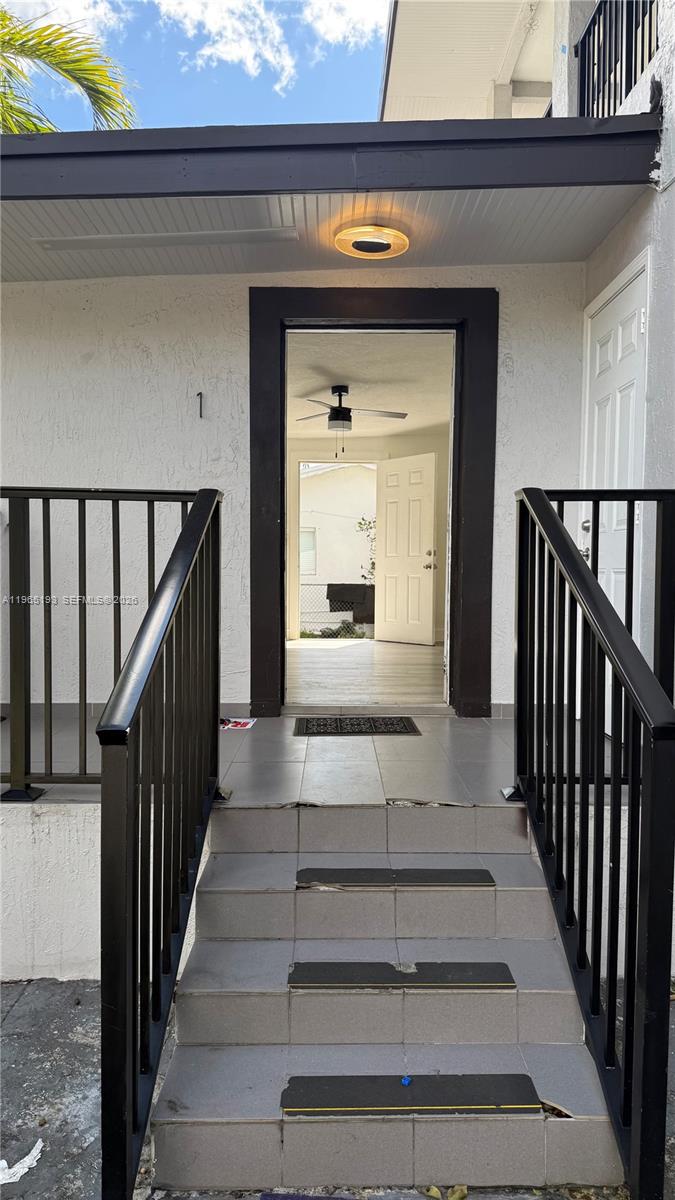 2238 Northwest 5th Street, Unit 1 Miami, FL 33125 - Photo 16 of 18 a view of staircase with wooden floor and a front door