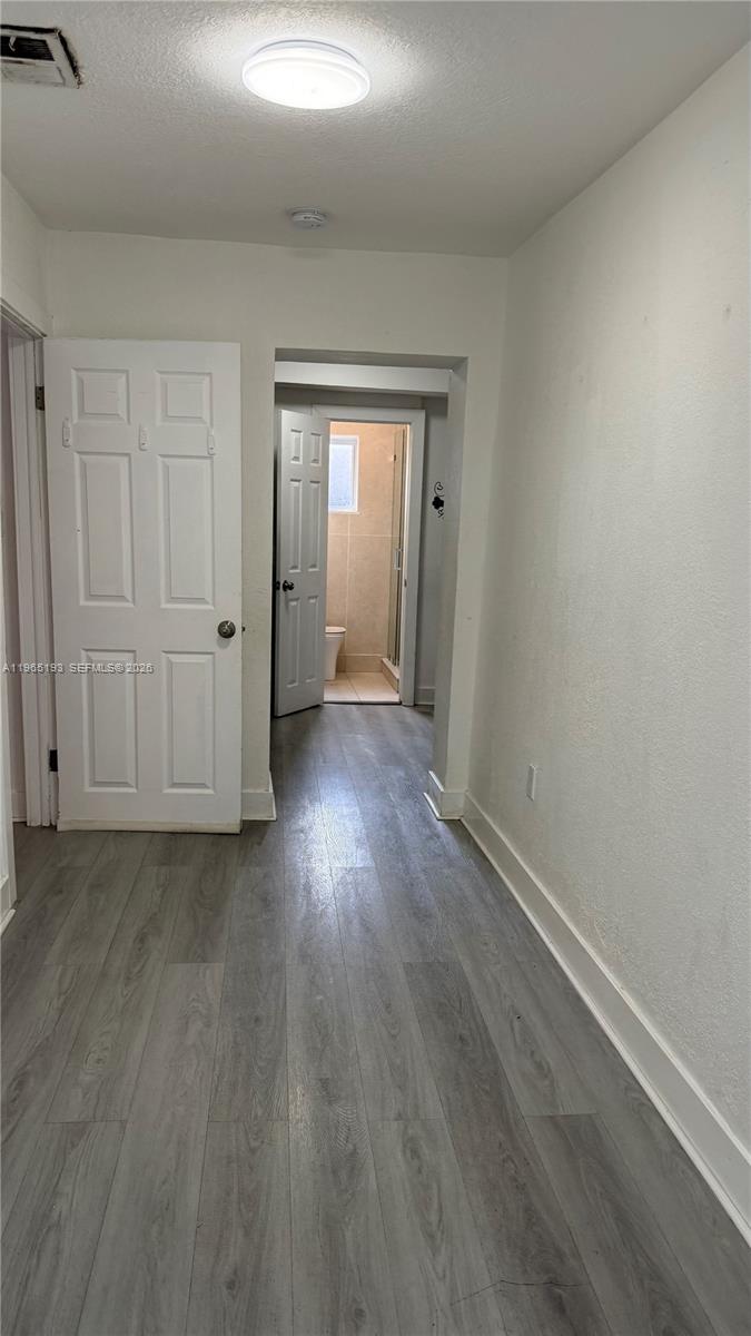 2238 Northwest 5th Street, Unit 1 Miami, FL 33125 - Photo 6 of 18 a view of a hallway with wooden floor