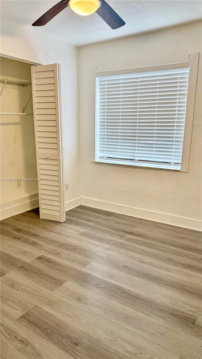 2238 Northwest 5th Street, Unit 1 Miami, FL 33125 - Photo 7 of 18 a view of a room with wooden floor and a window