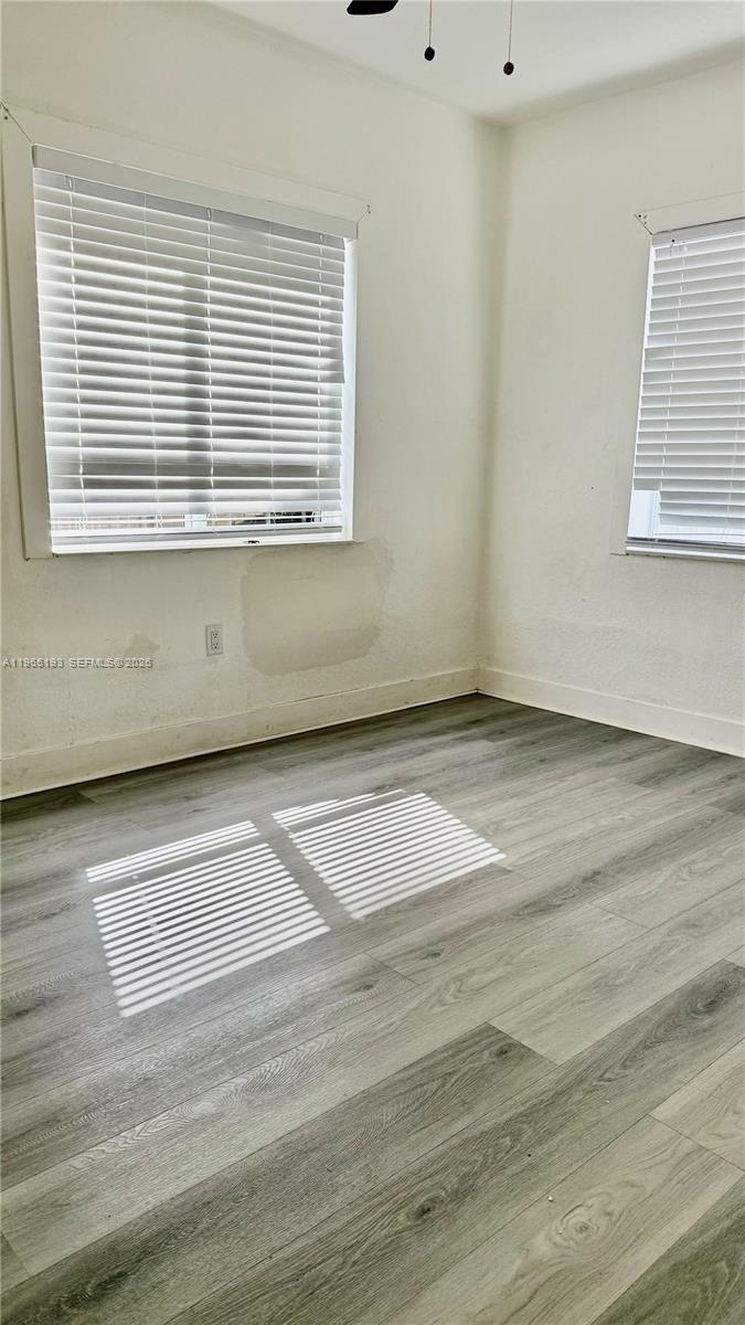 2238 Northwest 5th Street, Unit 1 Miami, FL 33125 - Photo 8 of 18 a view of a room with wooden floor and a window