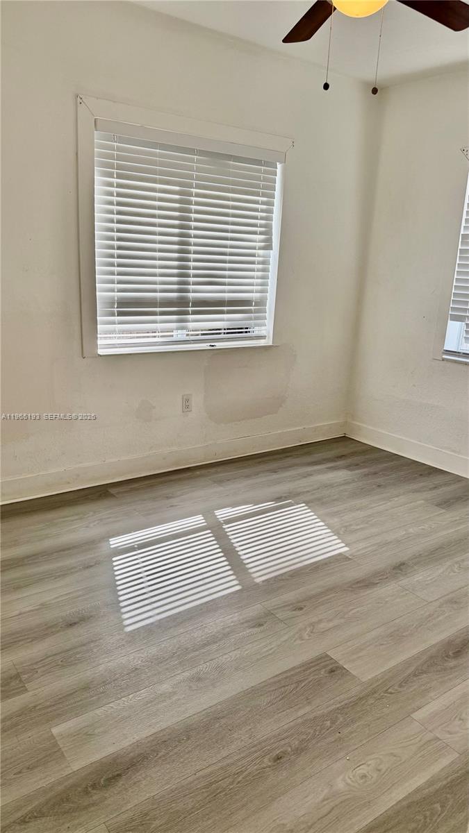 2238 Northwest 5th Street, Unit 1 Miami, FL 33125 - Photo 9 of 18 a view of a room with wooden floor and a window