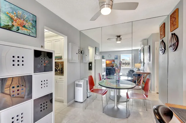 a view of a dining room with furniture and a chandelier