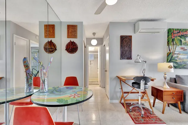 a dining room with furniture and rug