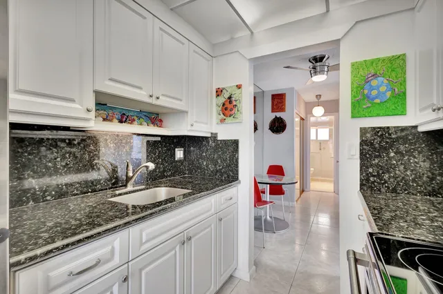a kitchen with stainless steel appliances granite countertop a sink and a microwave