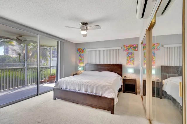 a spacious bedroom with a bed and a large window