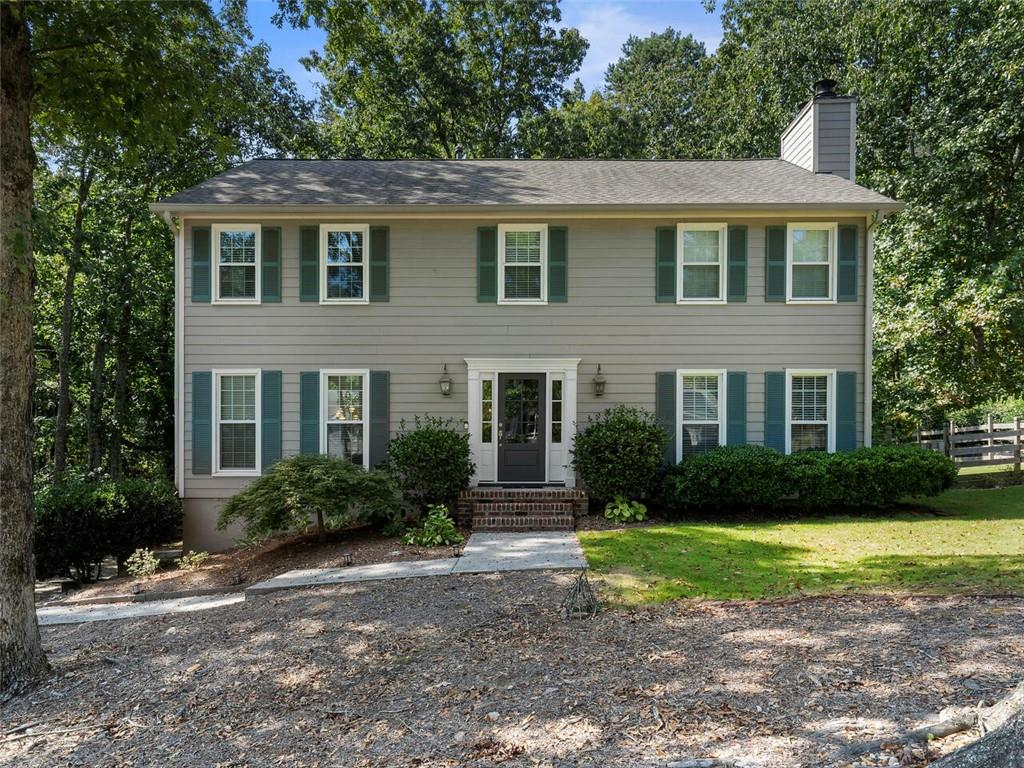 a front view of a house with garden