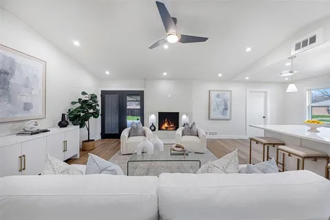 a living room with furniture and a large mirror