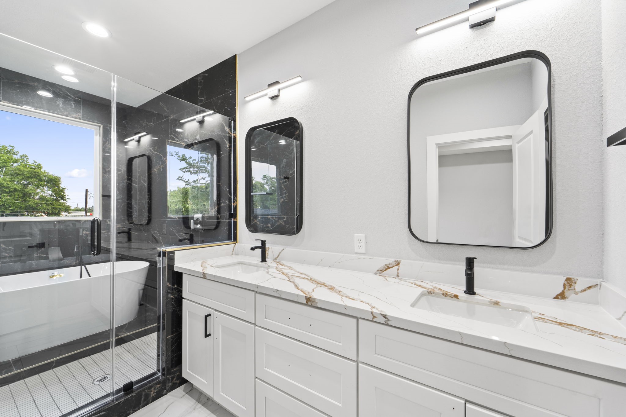 6631 Foster Street Houston, TX 77021 - Photo 14 of 21 a bathroom with 2 sink tub and a mirror