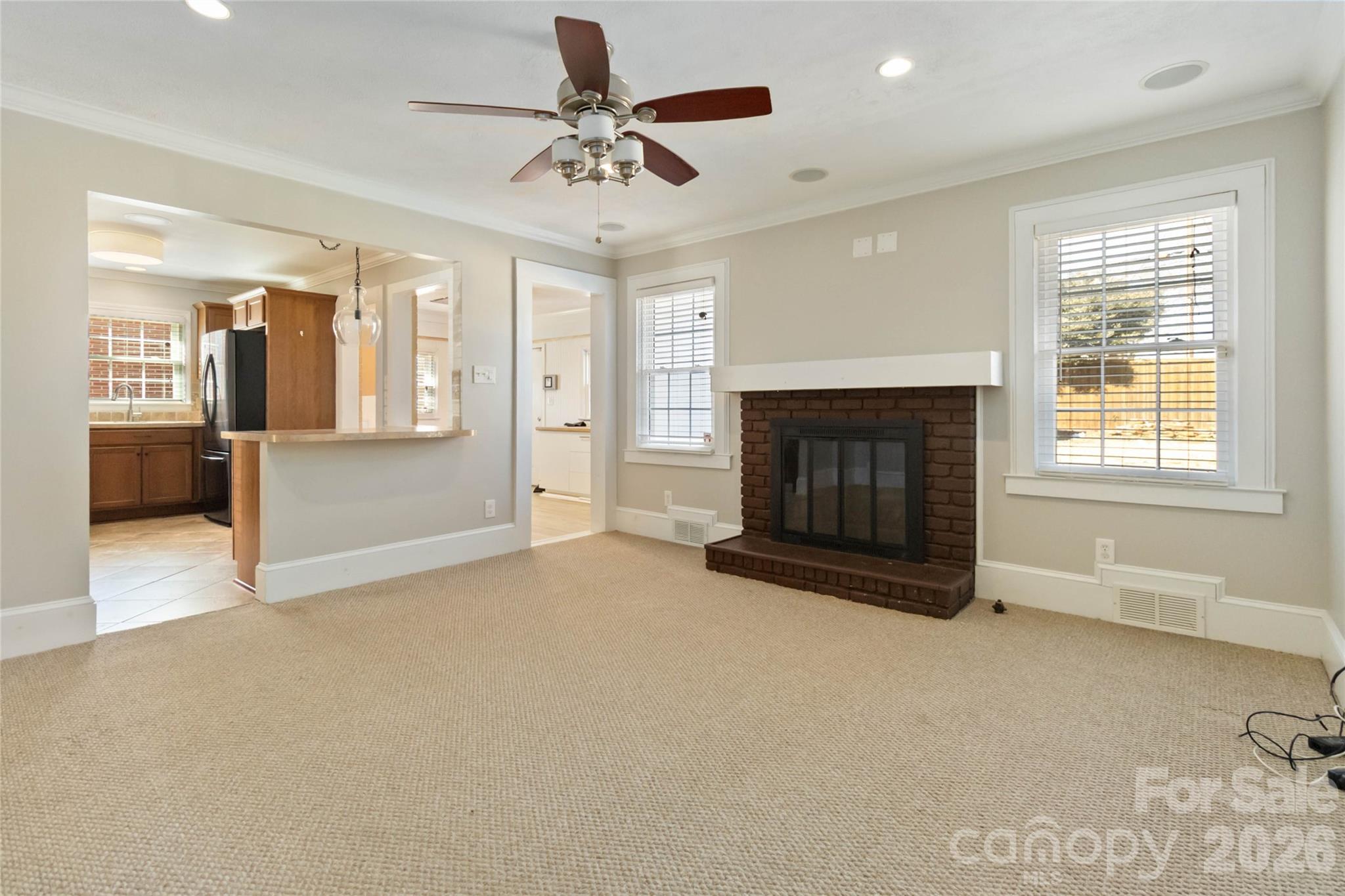 3750 Havenwood Road Charlotte, NC 28205 - Photo 11 of 37 a view of an empty room with a fireplace and a window
