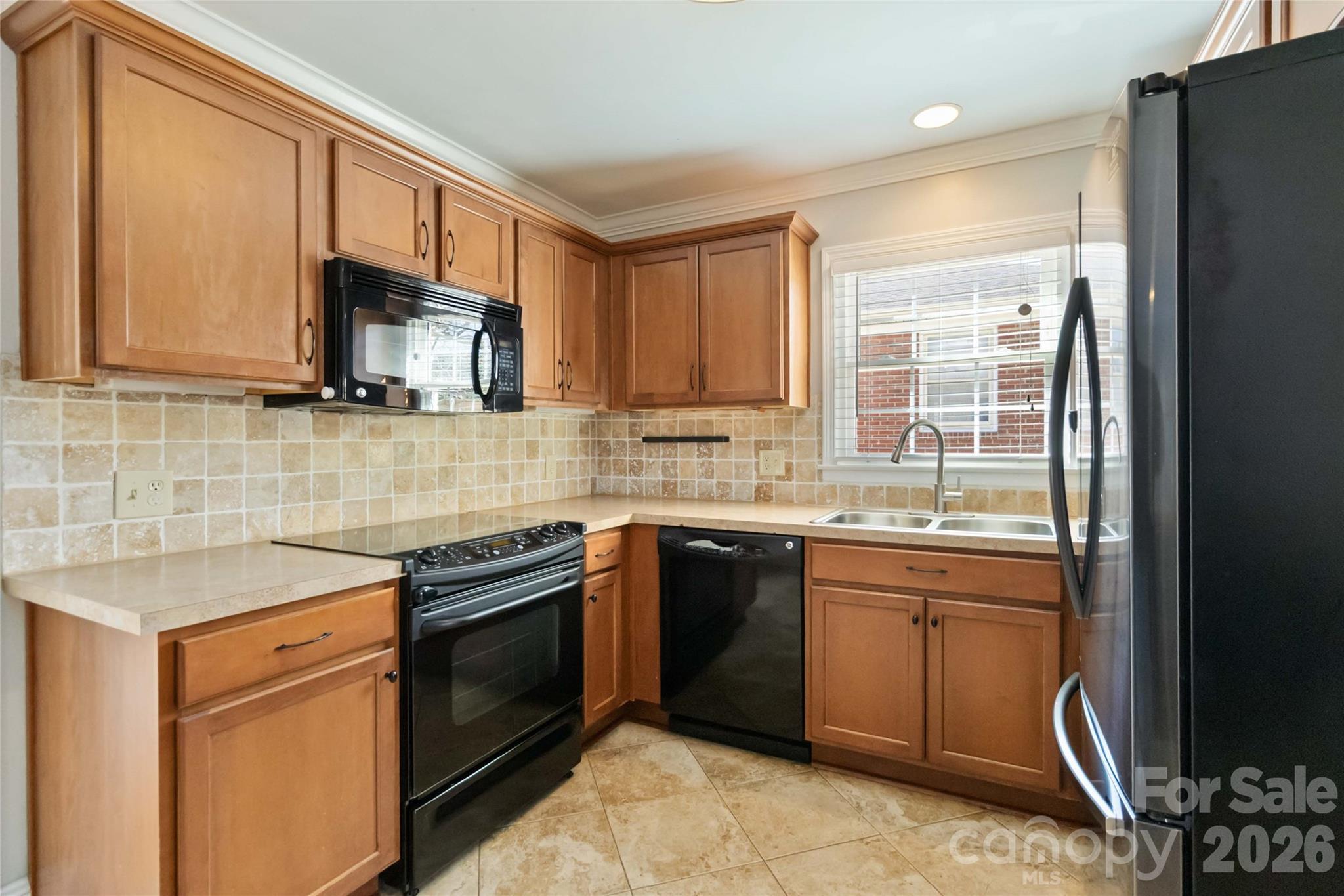 3750 Havenwood Road Charlotte, NC 28205 - Photo 15 of 37 a kitchen with stainless steel appliances granite countertop a sink stove and microwave