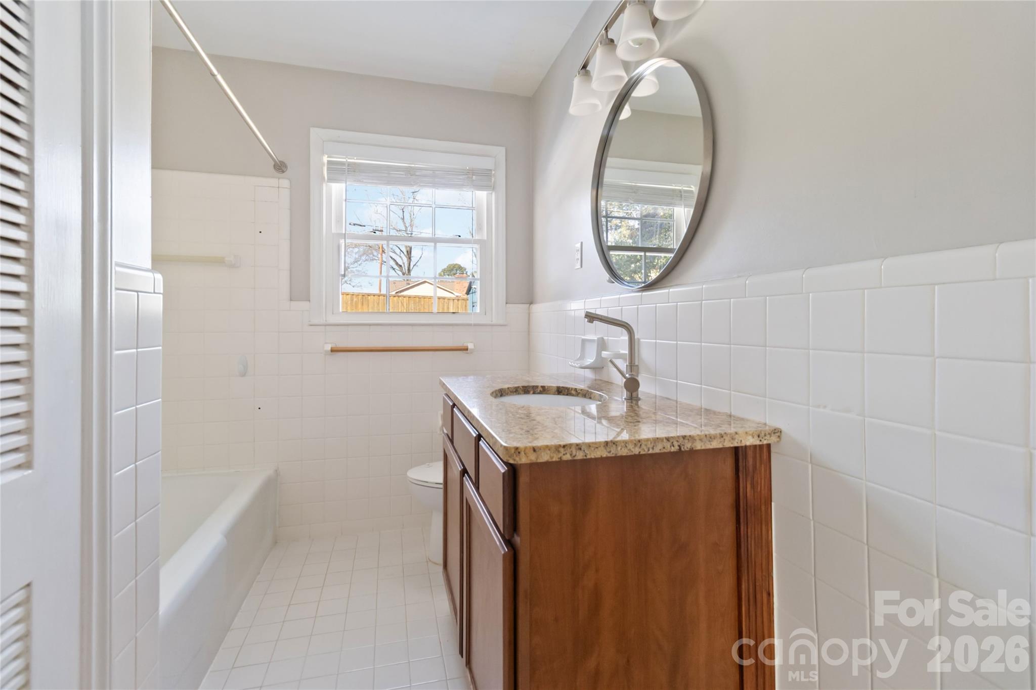 3750 Havenwood Road Charlotte, NC 28205 - Photo 22 of 37 a bathroom with a sink a mirror and a window