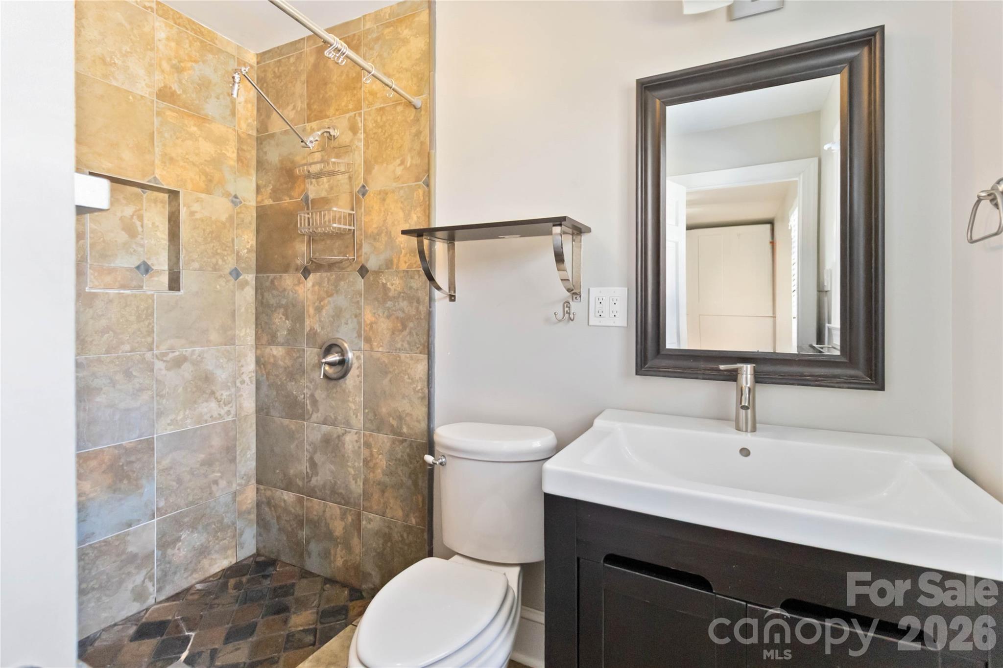 3750 Havenwood Road Charlotte, NC 28205 - Photo 31 of 37 a bathroom with a sink a toilet and shower