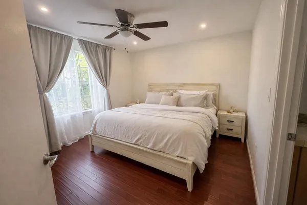 a bedroom with a large bed and a window