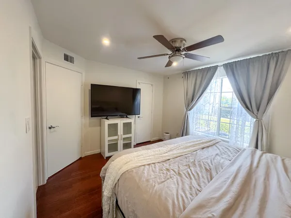 a bedroom with a bed and a flat screen tv