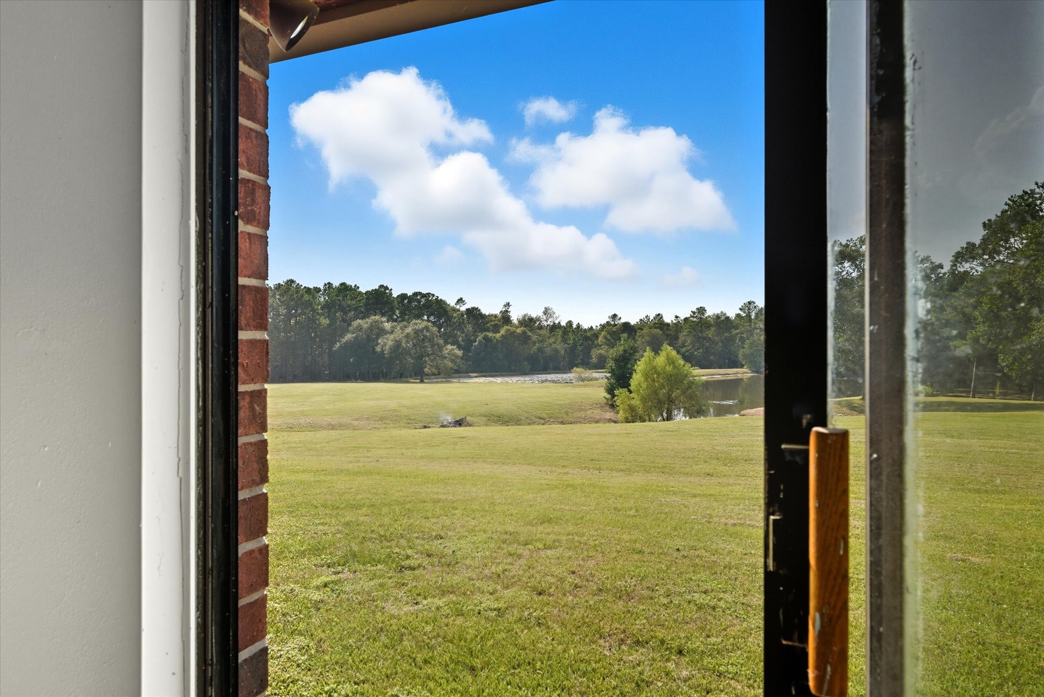 101 Merino Drive Huntsville, TX 77340 - Photo 13 of 42 A view from your home office (extra bedroom or bonus room) towards the pond.
