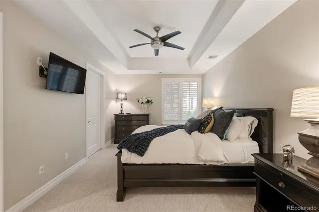 a bedroom with a bed window and a flat screen tv