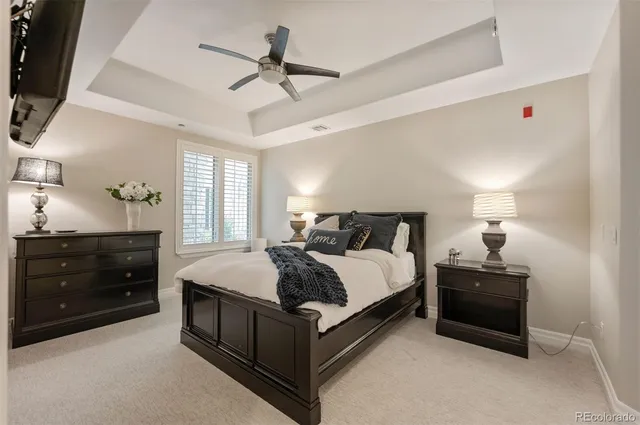 a bedroom with a bed and a ceiling fan